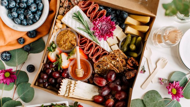 Beautiful charcuterie cheese board with nuts, meats, and fruits
