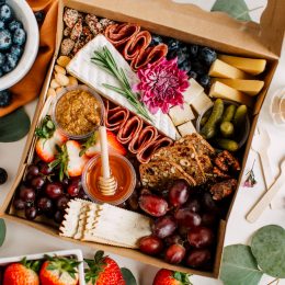 Beautiful charcuterie cheese board with nuts, meats, and fruits