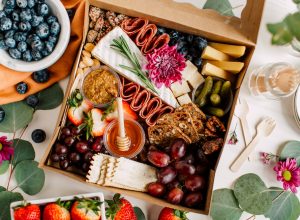 Beautiful charcuterie cheese board with nuts, meats, and fruits