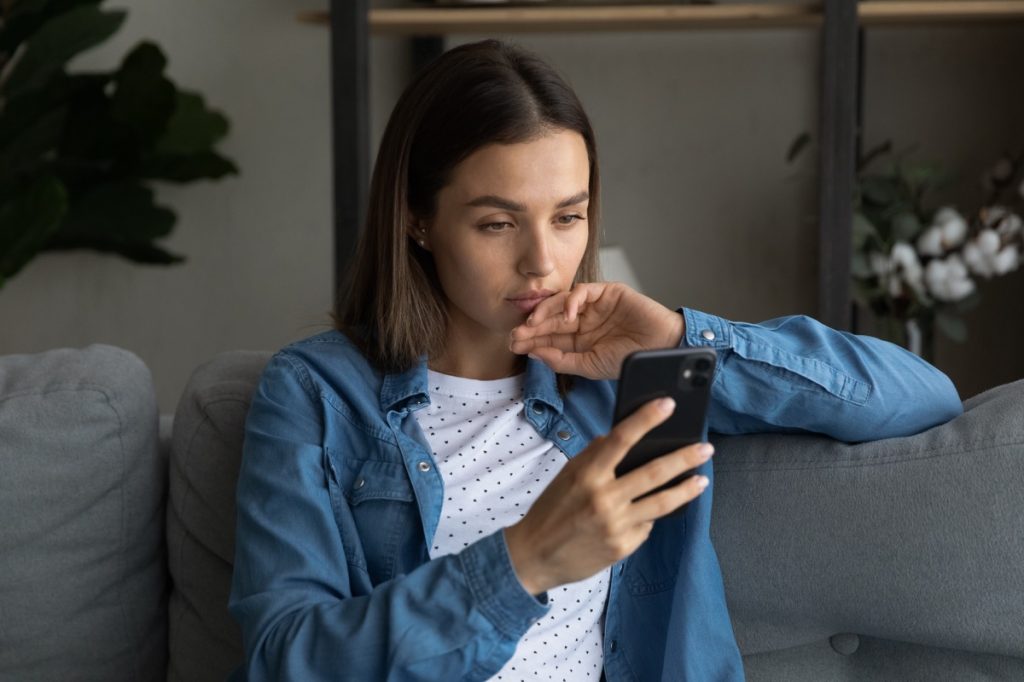 woman looking concerned at phone