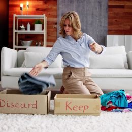 Stylish senior woman cleaning out and organizing her closet