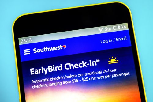 Southwest Airlines website homepage. Southwest Airlines logo visible on the phone screen.