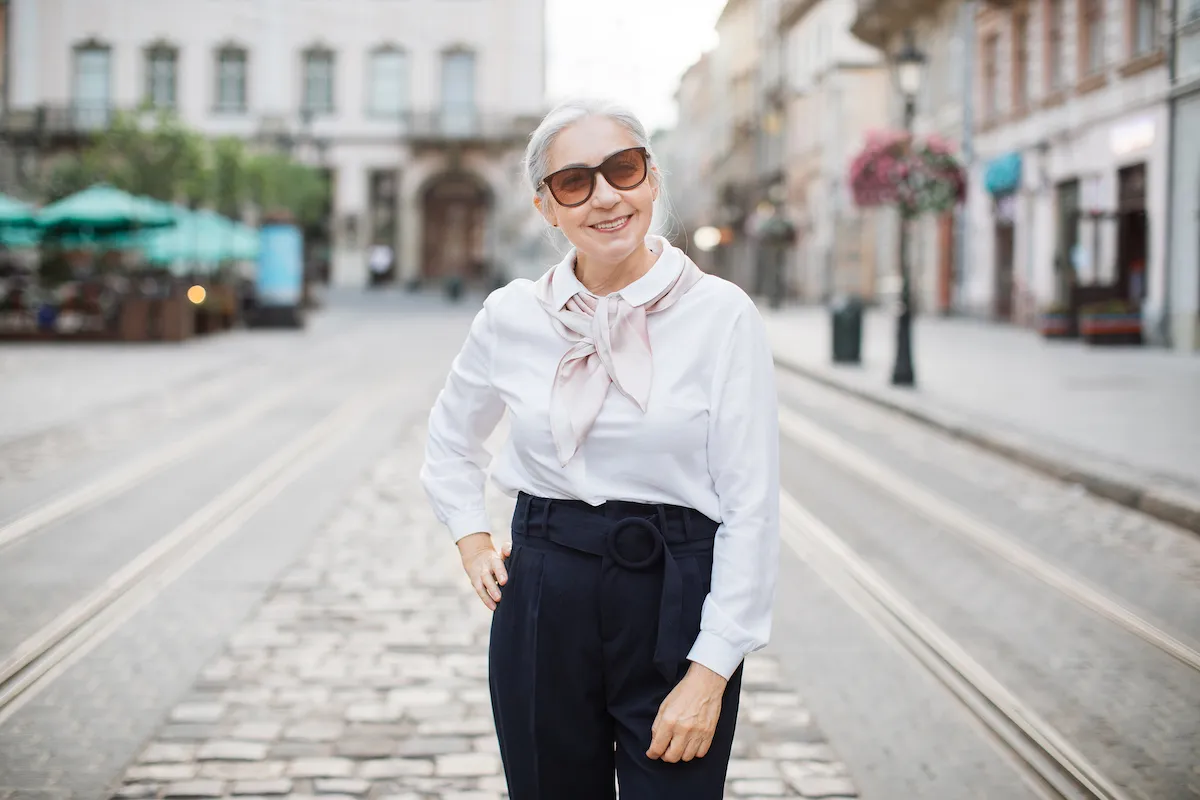 https://bestlifeonline.com/wp-content/uploads/sites/3/2023/08/stylish-woman-in-60s-posing-on-city-street.jpg?quality=82&strip=all