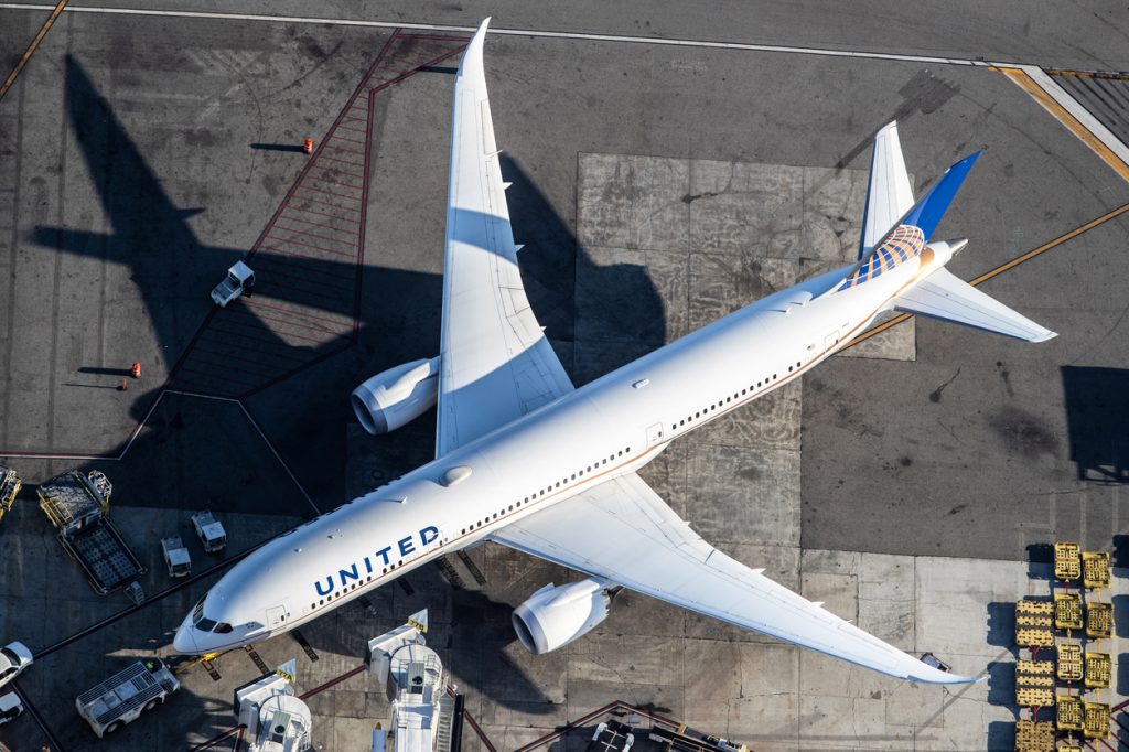 An aerial shot of a United Airlines plane sitting on a runway