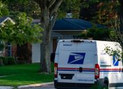 One of the newer Sprinter model USPS mail delivery trucks on a residential street in Rochester, Michigan.