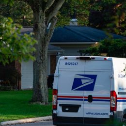 One of the newer Sprinter model USPS mail delivery trucks on a residential street in Rochester, Michigan.