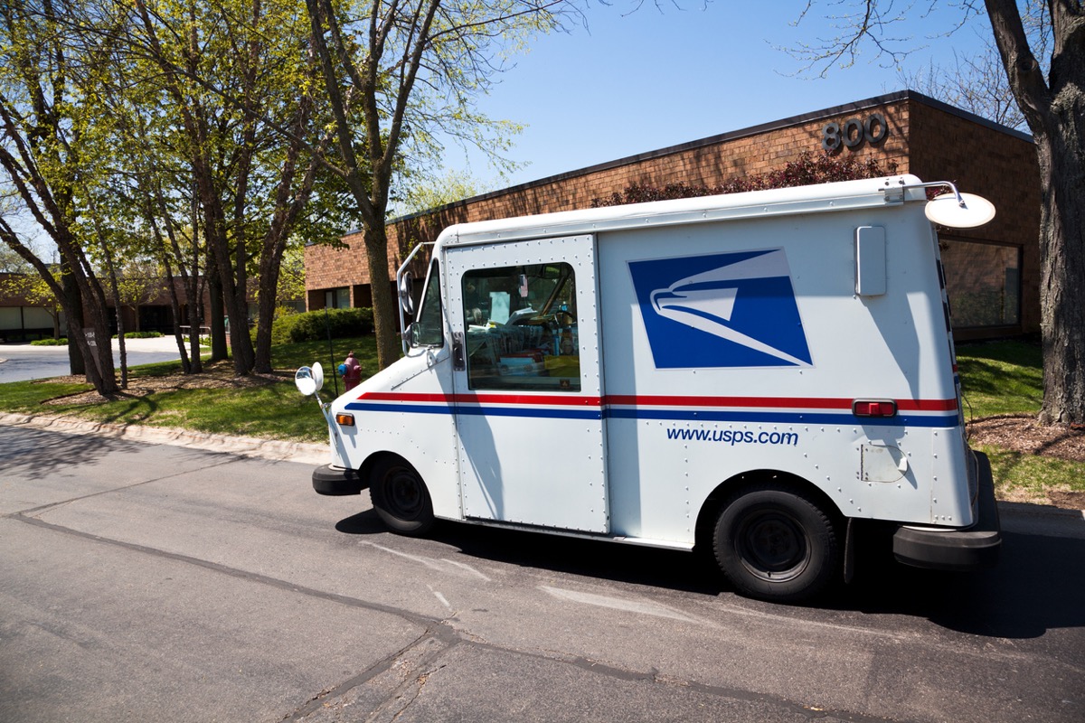 Northbrook, USA - May 14, 2013: United States Postal Service delivery truck distributing mail in office complex in Northbrook - suburban town north of Chicago.