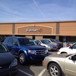 Walmart store and parking lot on a busy Saturday afternoon. Walmart is the largest retailer in the world. Photographed with an iPhone.