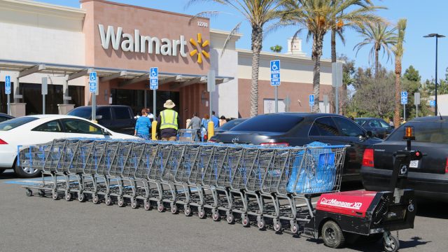 Cerritos, California, USA - April 18, 2016: Carts in parking lot are being pushed by CartManager XD, a shopping cart pusher, to make cart retrieval more efficient and safe.