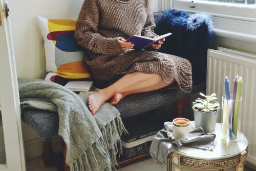 Woman sitting in an cozy reading nook
