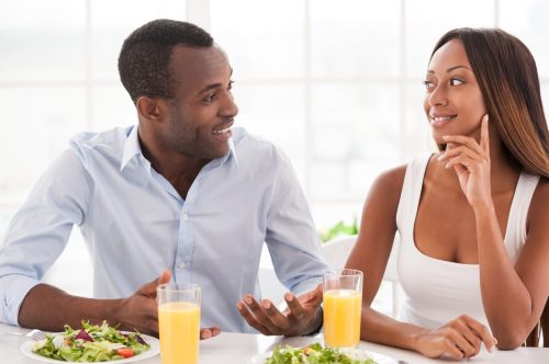 Black Couple Having Breakfast and Listening to Each Other