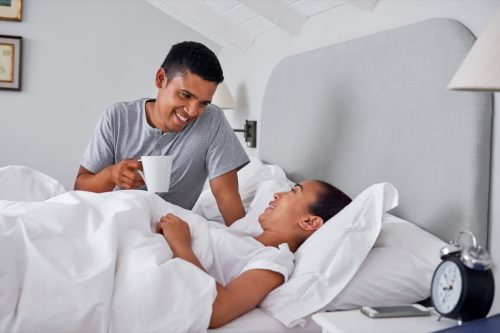 Man Bringing Woman Coffee in Bed