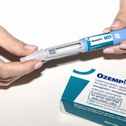 Close up of hands holding Ozempic drug