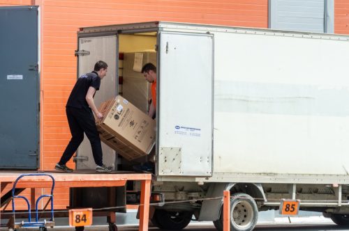 Petrozavodsk, Russia - 6 June 2022. movers load a washing machine into a delivery truck
