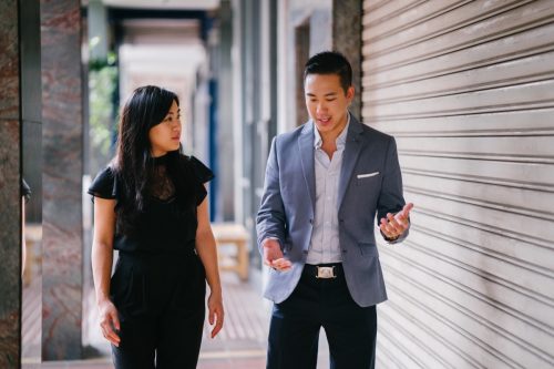 Man and woman professional having a serious conversation while walking