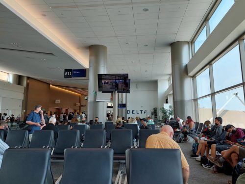 Passengers seated, waiting in a Delta Air Lines hold room at Salt Lake City International Airport (KSLC)'s new terminal. The new terminal opened in 2020.