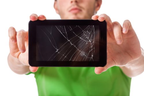 man holding up a broken cellphone screen