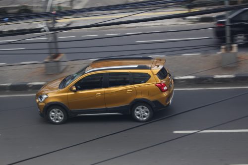 Gold SUV car driving along on high speed highway