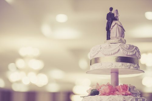 bride and groom toppings on multi-tier wedding cake