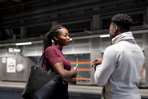 man and woman making small talk on subway platform