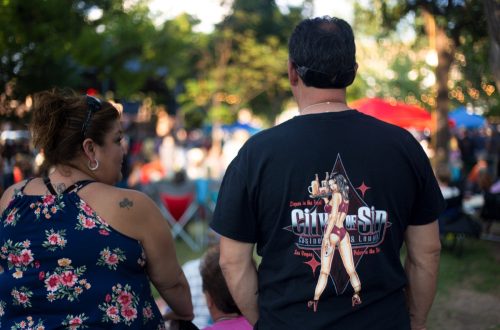 A middle-aged couple—one with a tattoo and another with a sexy T-shirt—standing on the historic Santa Fe Plaza.