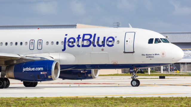 A JetBlue plane taxiing on a runway