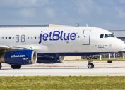A JetBlue plane taxiing on a runway