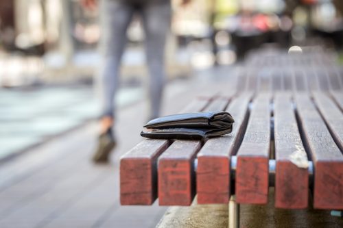man lost his wallet on a bench on street