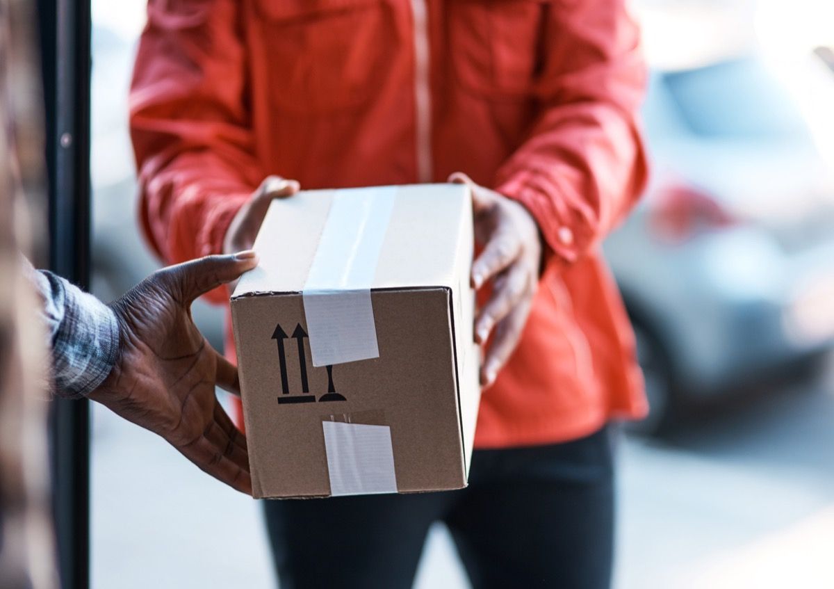 Cropped shot of a delivery man handing over a package