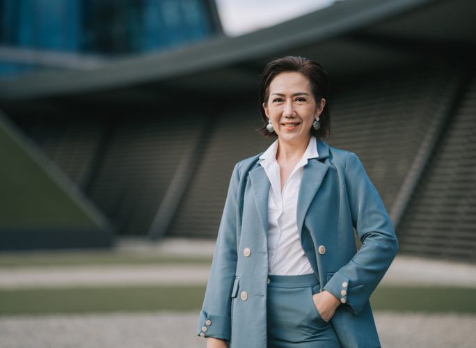 successful Asian Chinese female entrepreneur looking at camera smiling