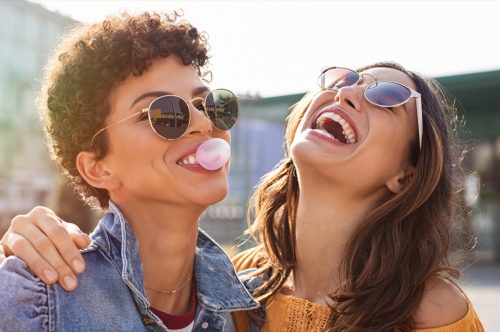 two female friends laughing and blowing bubbles