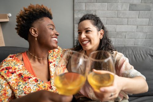 two women drinking wine celebrating their anniversary