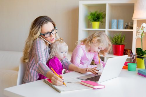 busy mom trying to work with children