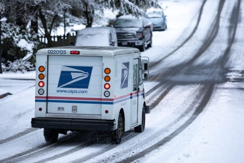 usps truck driving in the snow