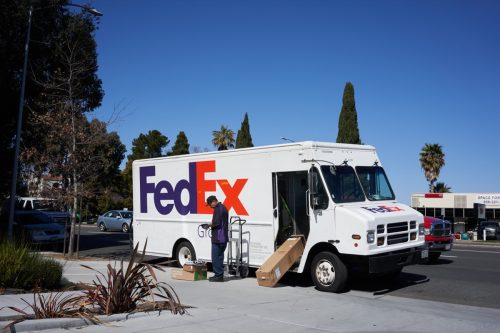 fedex driver delivering package