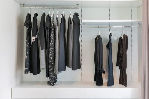 Closet with black and neutral clothes