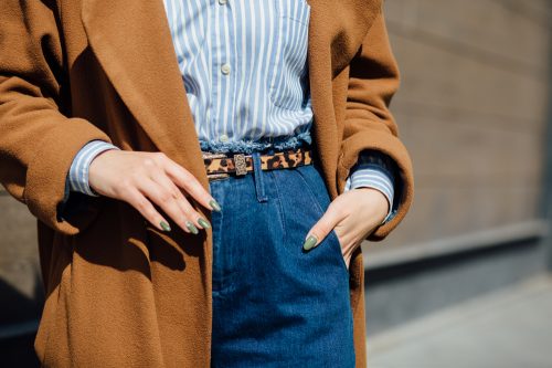 Style concept with wool coat, jeans, and leopard print belt