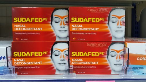 Selective focus view of Sudafed Sinus and Pain Relief medicine on the shelves at local pharmacy. Sinus congestion and pressure, headaches medication. Winter cold.