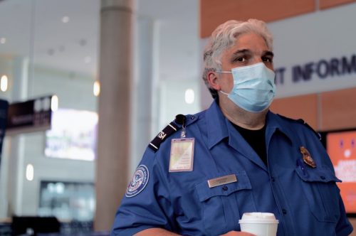Windsor Locks, Connecticut / United States - May 28 2020: TSA Agent at Bradley International Airport watches over travelers as they come and go