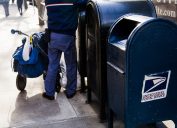 USPS worker emptying the mailbox on a MAnhattan street in New-York, USA on November 17, 2012.