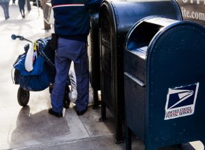 USPS worker emptying the mailbox on a MAnhattan street in New-York, USA on November 17, 2012.