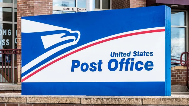 A close up of a U.S. Post Office sign