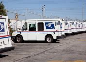 United States Post Office mail delivery trucks await deployment in Redondo Beach, California.