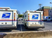 Ephrata, PA, USA - April 4, 2021: USPA Mail delivery trucks parked at the Ephrata Post Office in Lancaster County, PA.