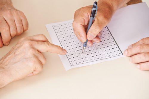 close-up of two people doing a word search together