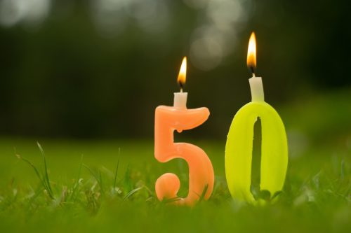 Figure 50 candles with fire on the green grass