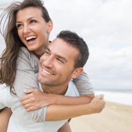 portrait of happy young couple at the beach