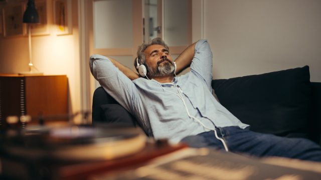 Mid,Aged,Man,Listening,Music,With,Headphones,On,Phonograph,,Relaxed