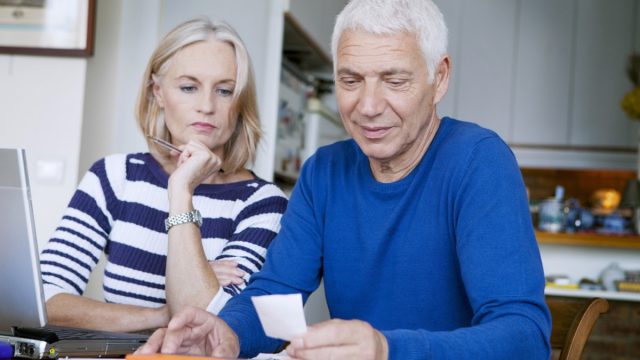 Senior couple reviewing finances bills