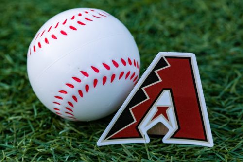 The emblem of the Arizona Diamondbacks baseball club and a baseball.